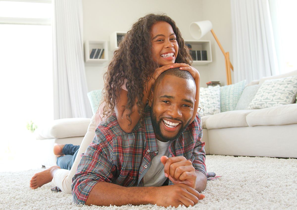 Happy couple enjoying their freshly painted home interior