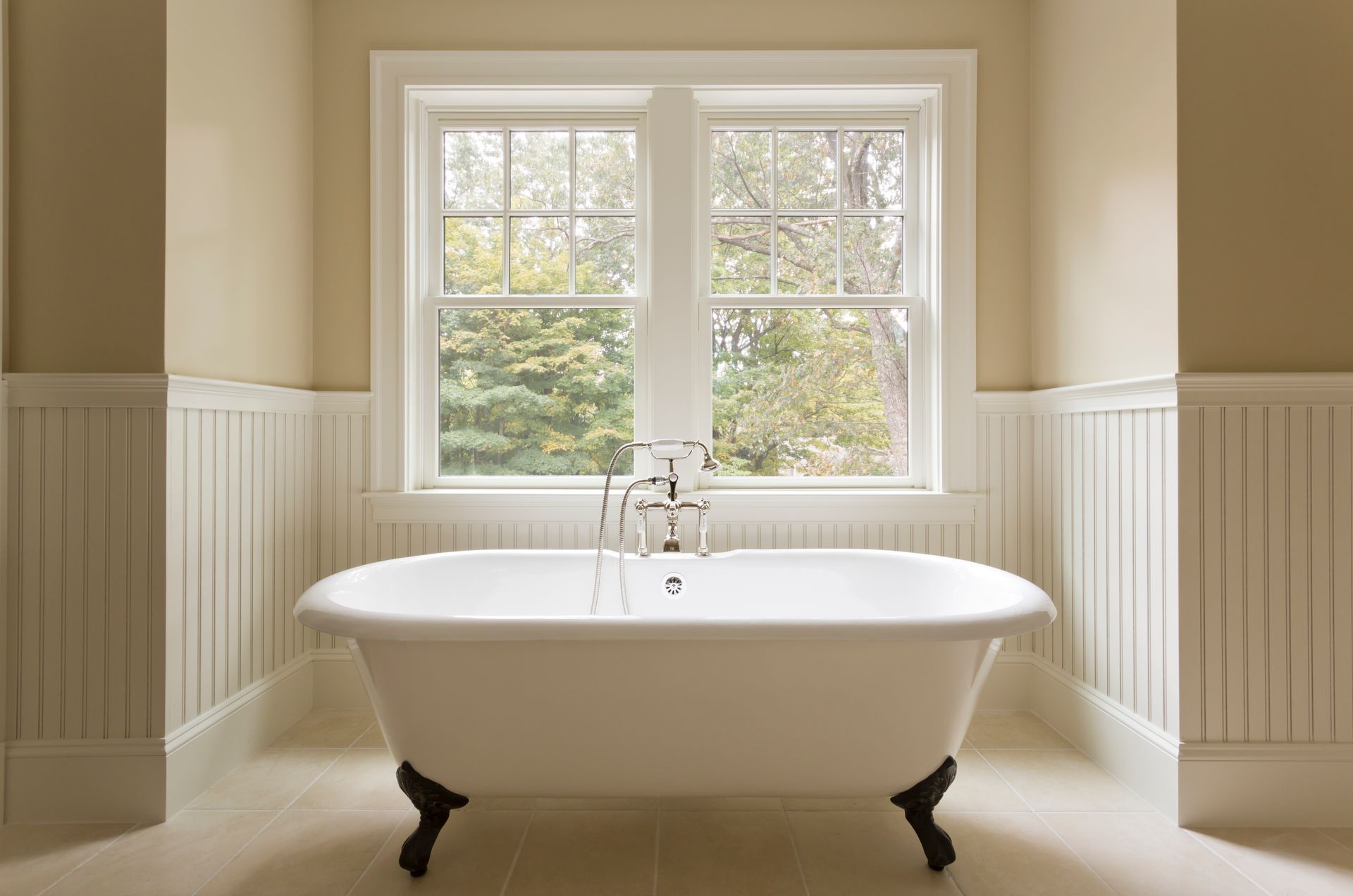 A bathroom with a bathtub and a window.