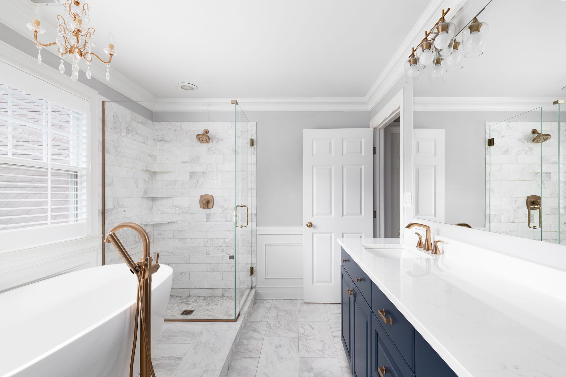 A bathroom with a sink, toilet and mirror.