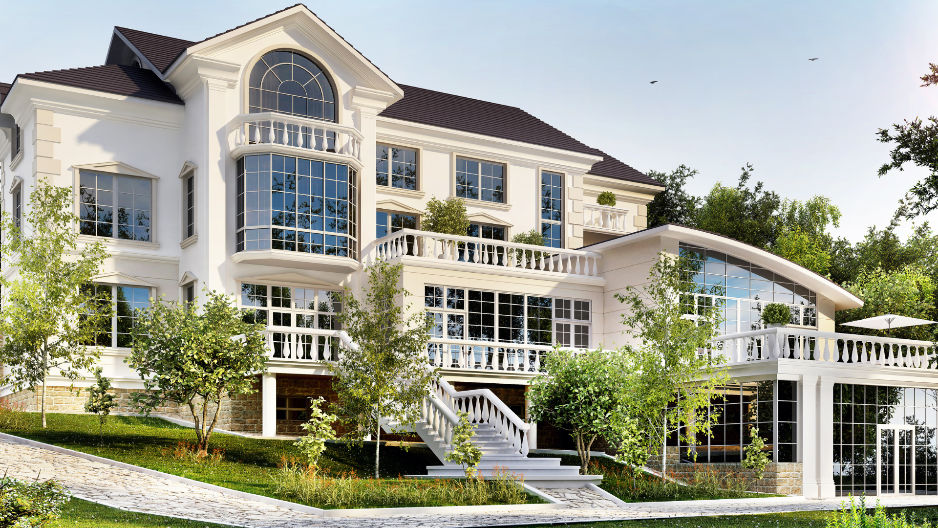 A large white house with a lot of windows is surrounded by trees