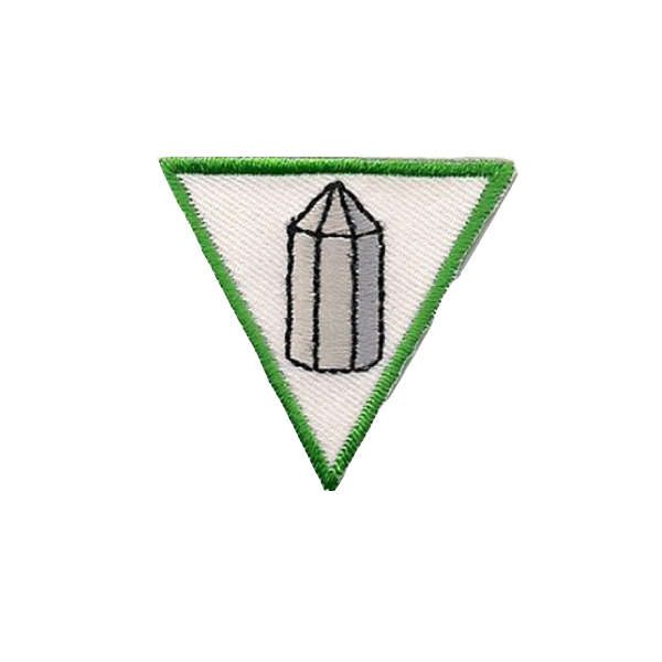 A white triangle with a green border and a crystal on it badge.