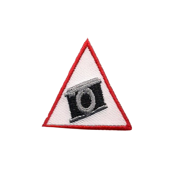 A red and white triangle with a camera on it badge.