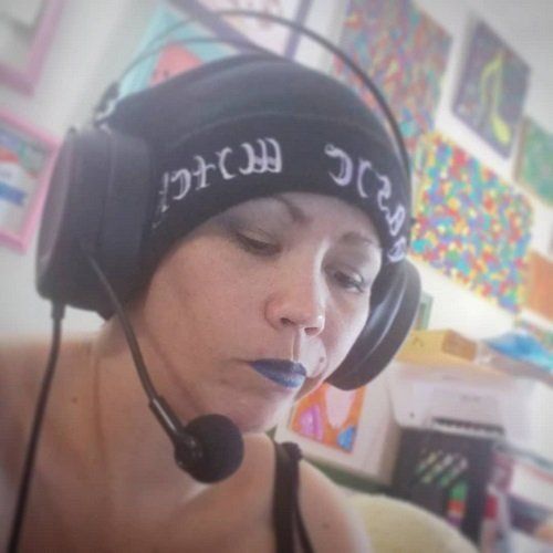 A woman wearing headphones and a beanie with the word music on it, Korianne.