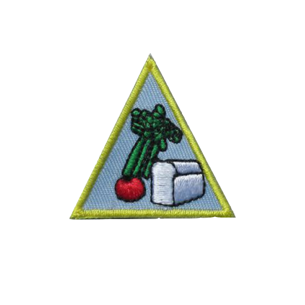 A triangle with a picture of vegetables on it badge.