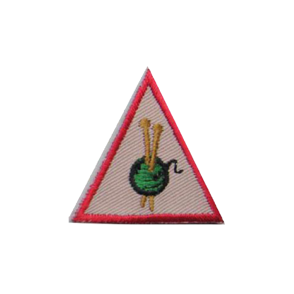 A triangle with a green ball of yarn on it badge.