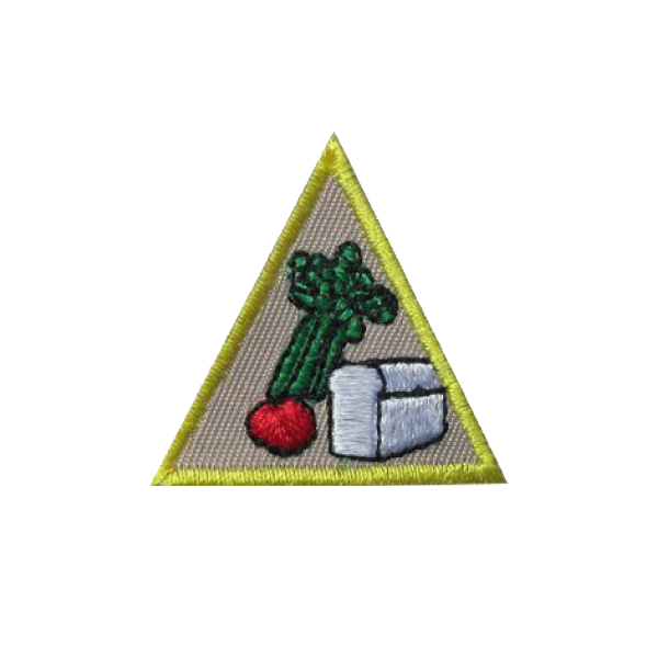 A triangle with a radish and asparagus on it badge.