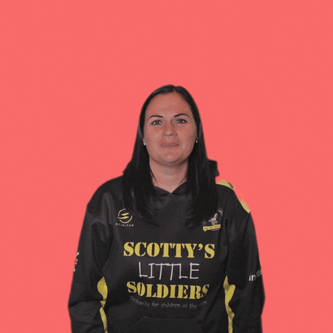 A woman wearing a black shirt that says scotty 's little soldiers