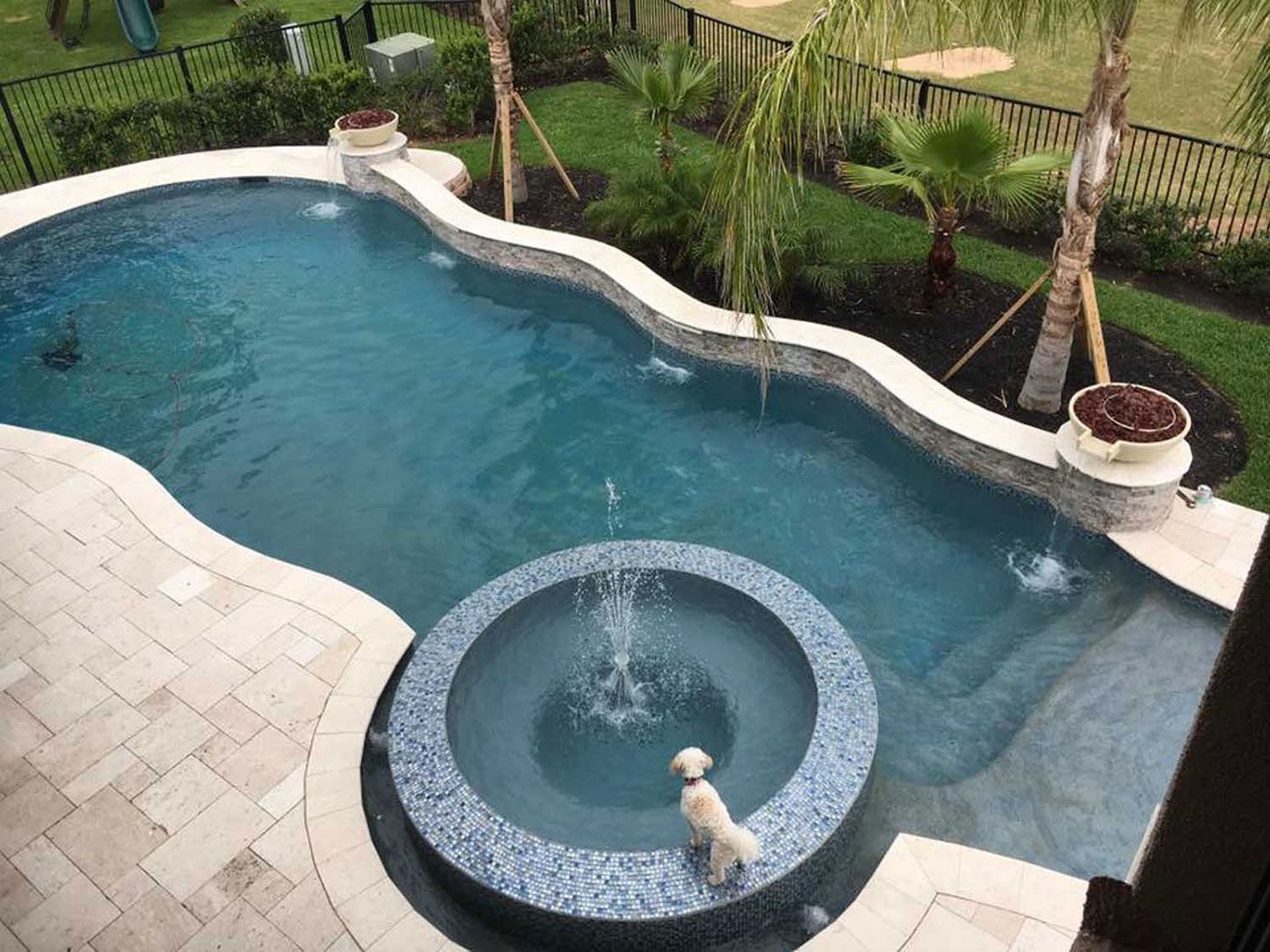 A large swimming pool with a fountain in the middle of it.