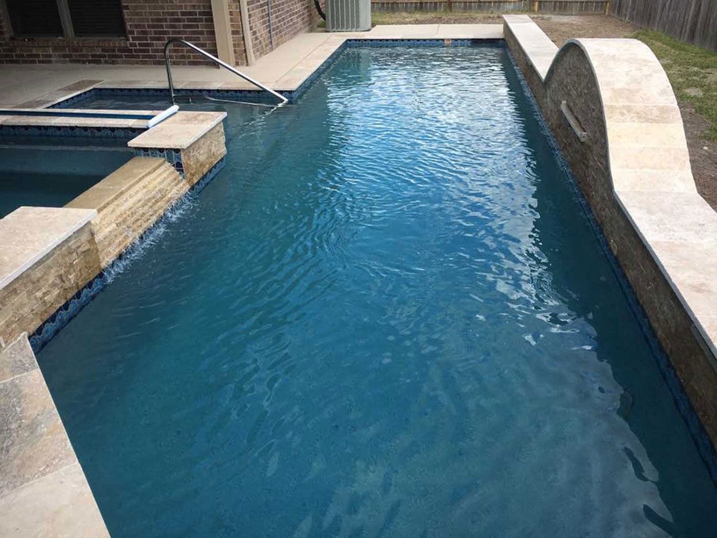 A large swimming pool with a staircase leading to it.