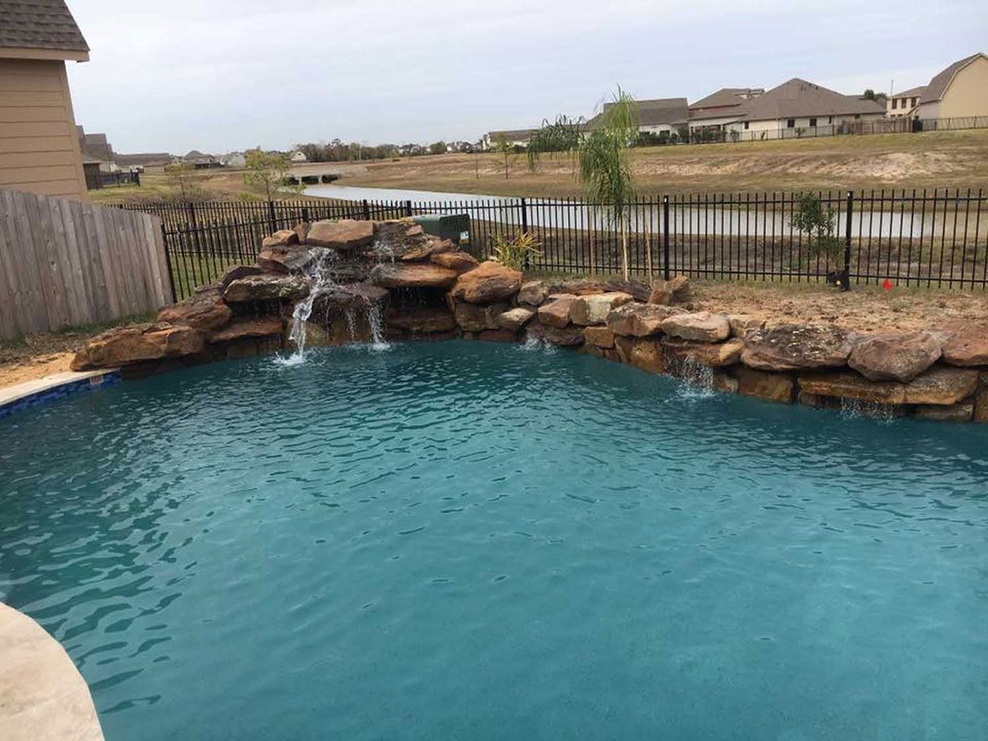 There is a waterfall in the middle of the pool.