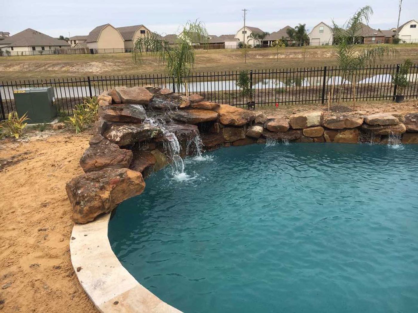 There is a waterfall in the middle of the pool.