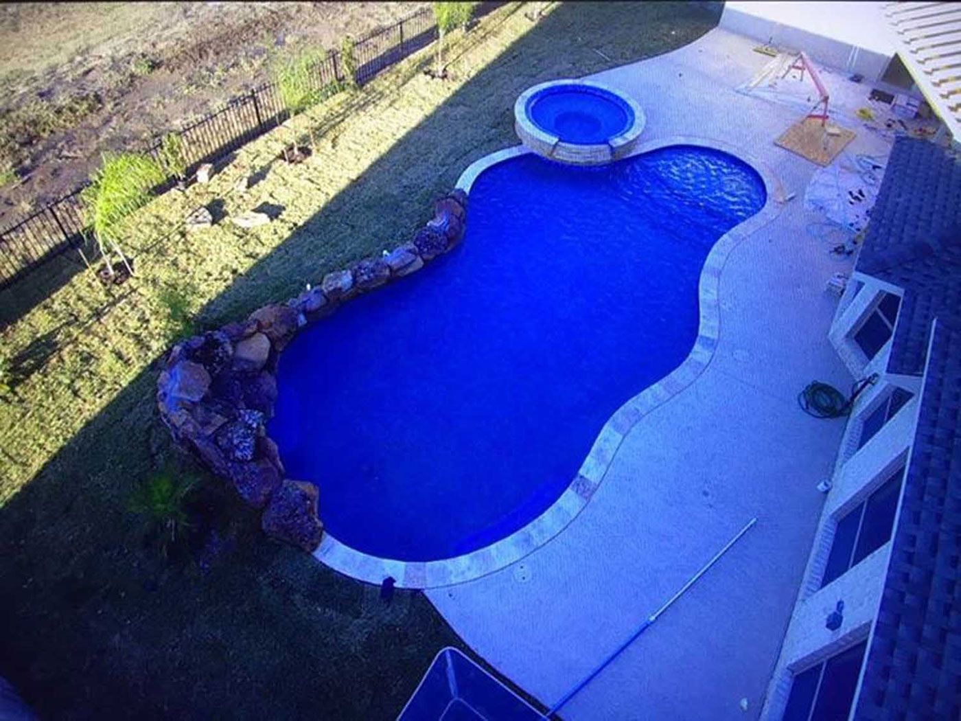 An aerial view of a large blue swimming pool