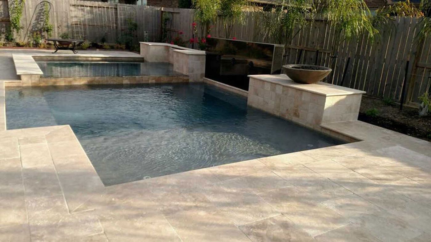 There is a large swimming pool in the backyard.