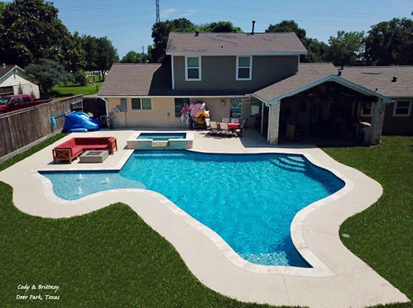 A large swimming pool in the backyard of a house