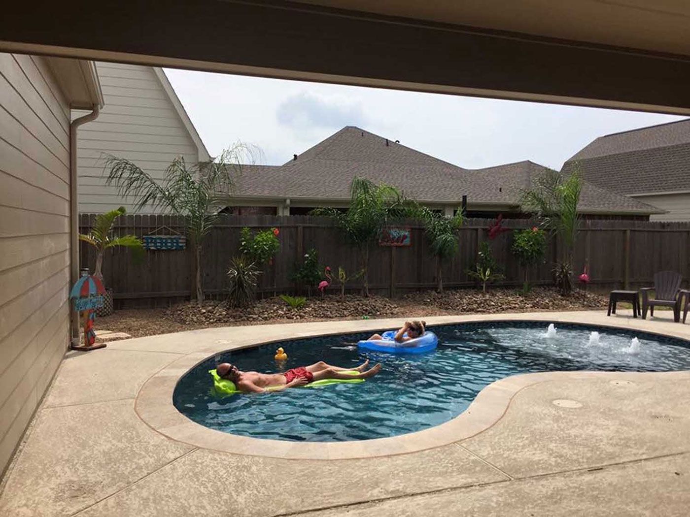 A man is laying on a raft in a swimming pool.