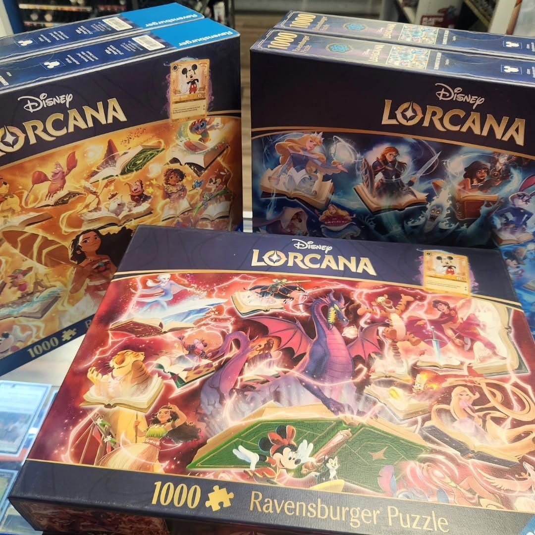 Disney Lorcana puzzle boxes with colorful character artwork, stacked on a tabletop.