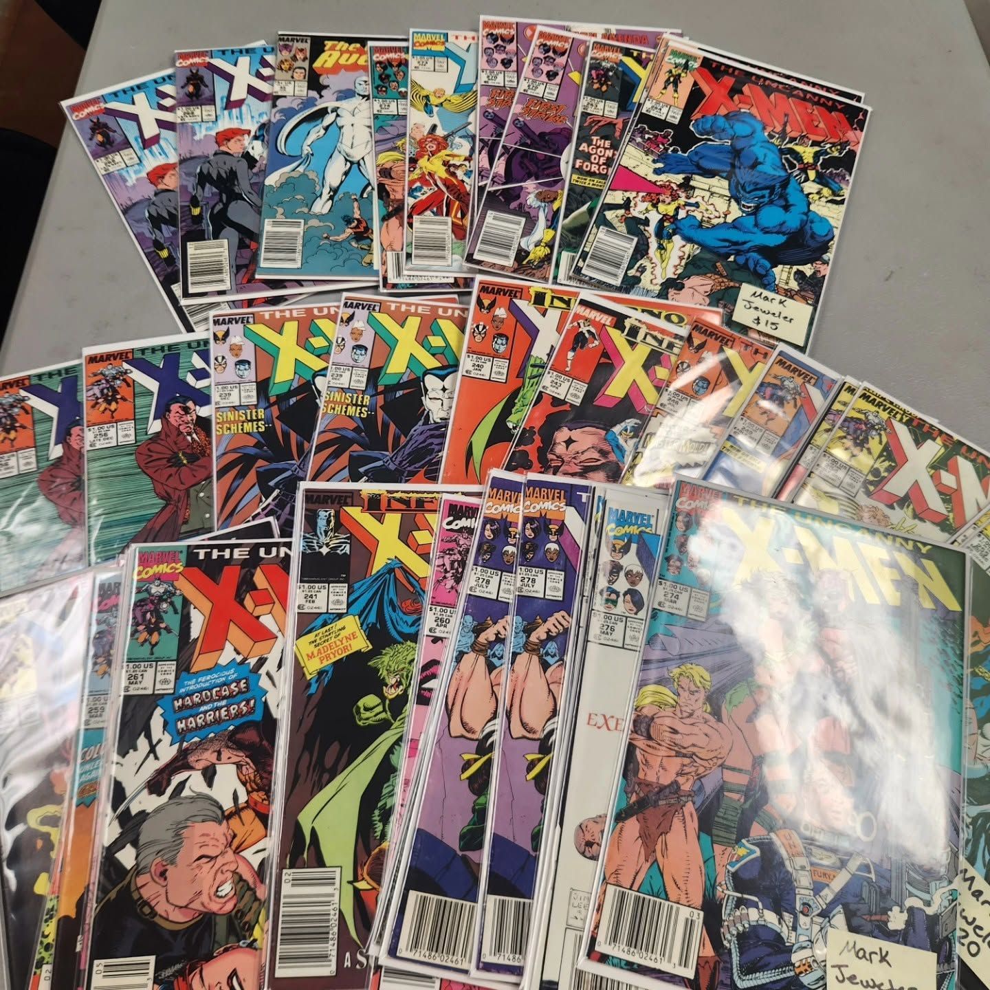 Assorted X-Men comic books arranged in a fan pattern on a flat surface.