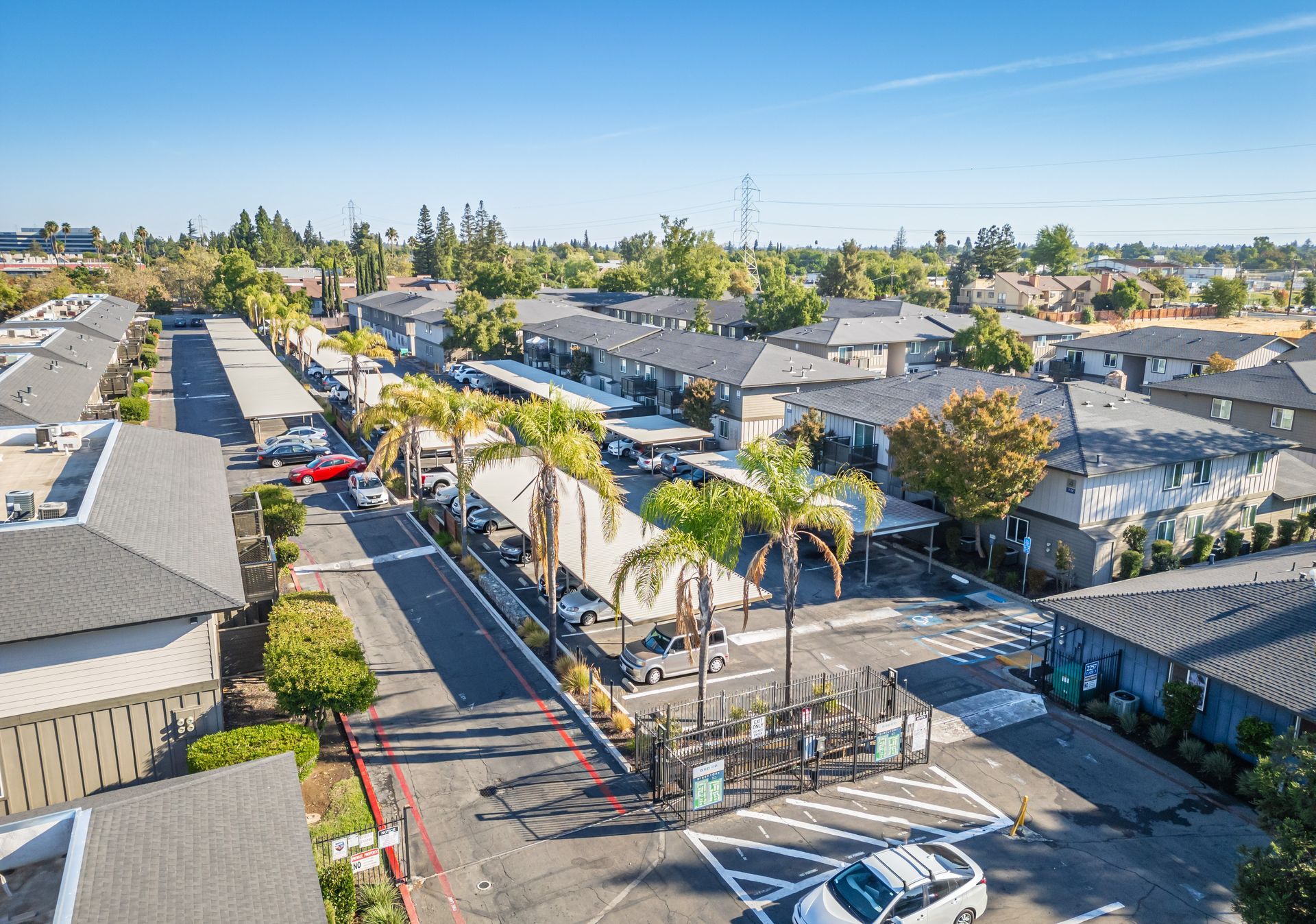 An aerial view of a residential area with lots of houses and palm trees.