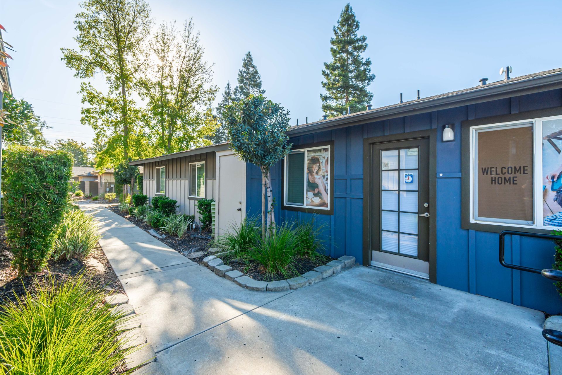 A blue building with a sign that says welcome home