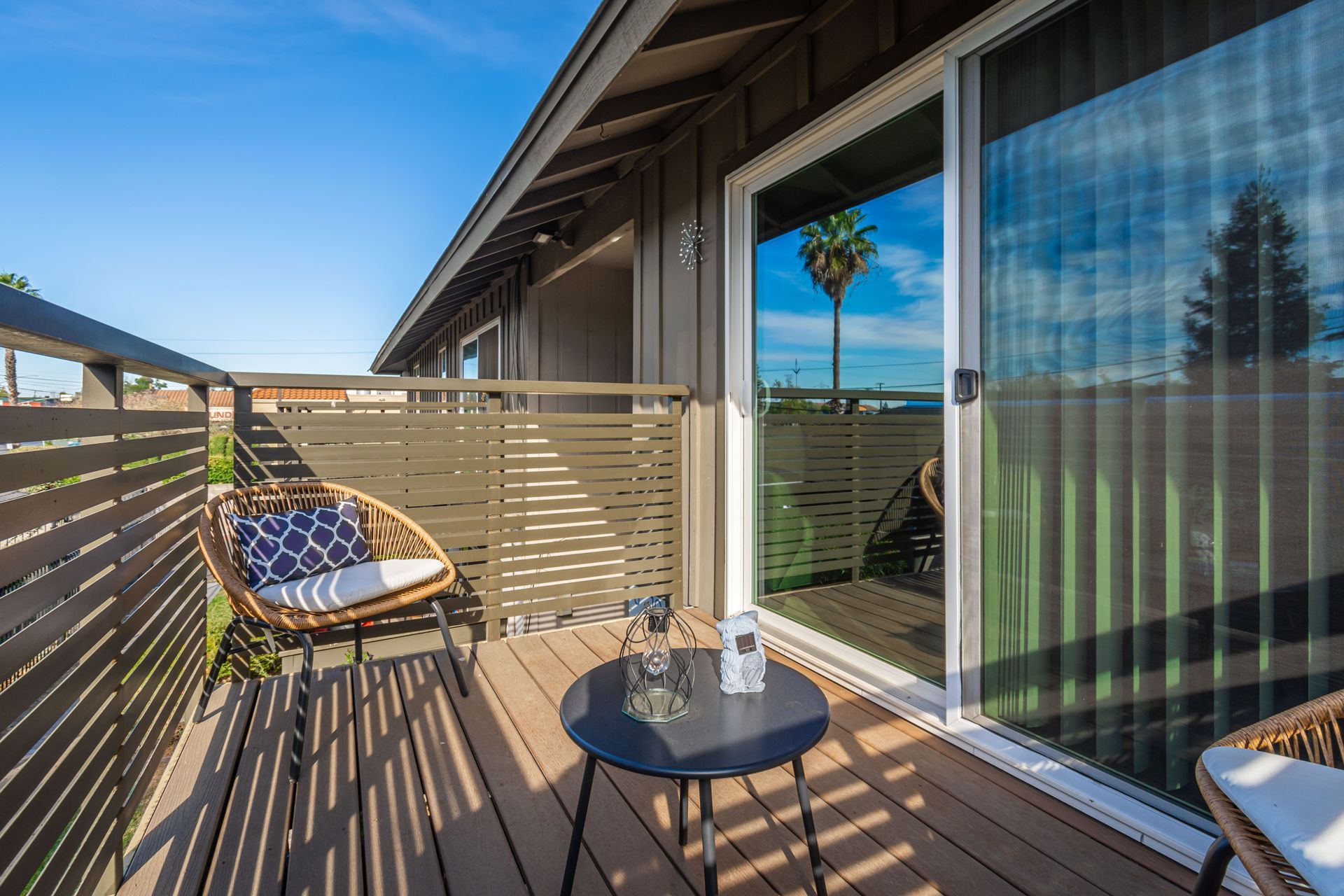 There is a balcony with a table and chairs on it.