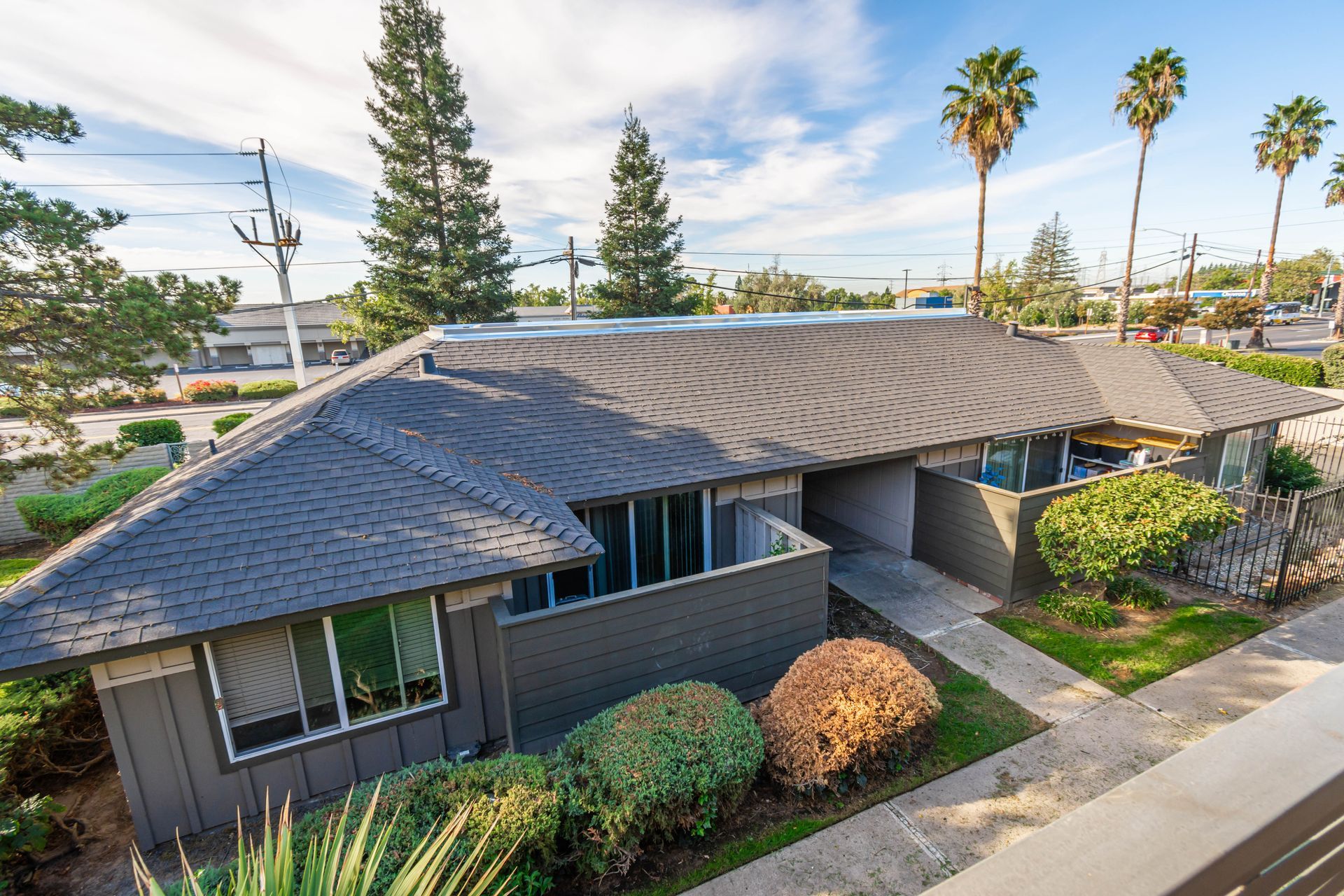 An aerial view of a house with a gray roof