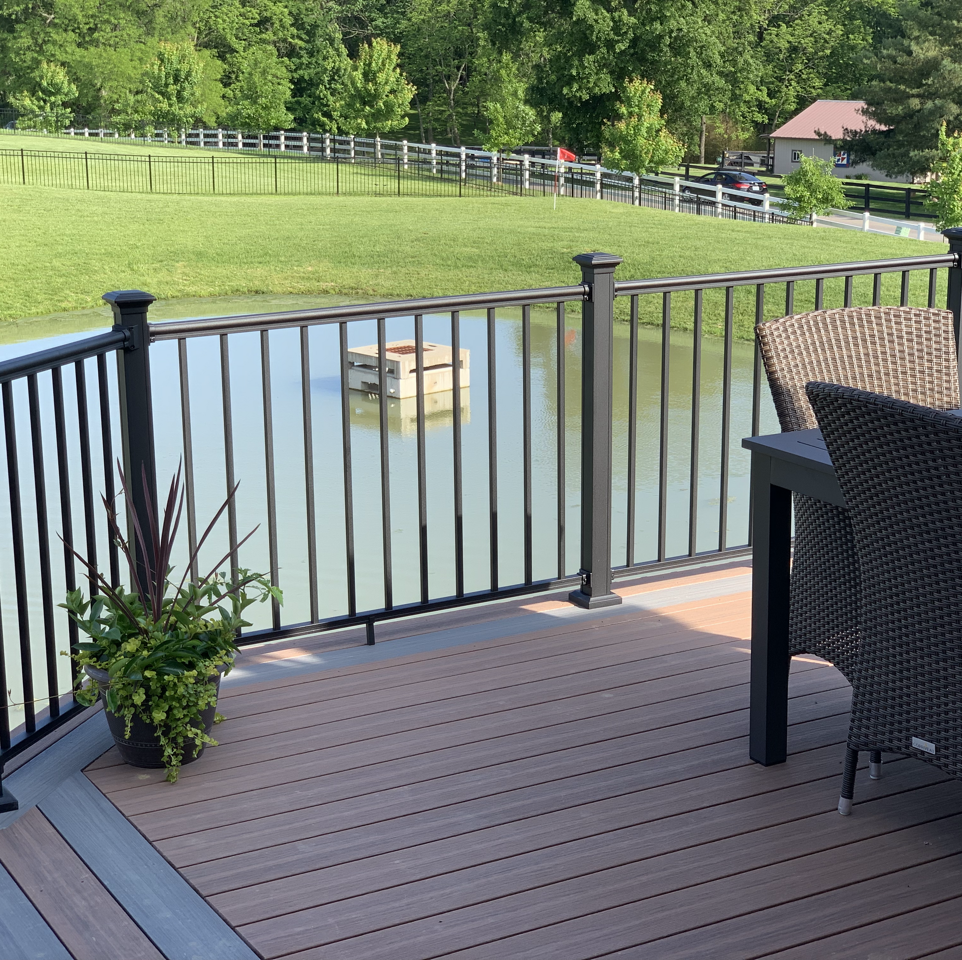A deck with a railing overlooking a body of water
