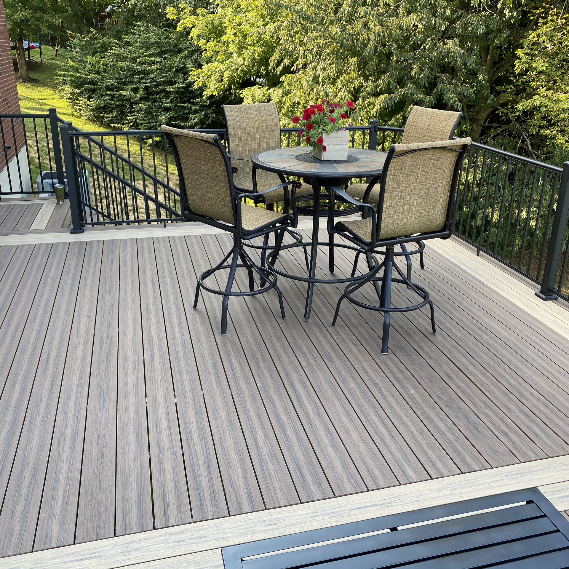 A deck with a table and chairs on it