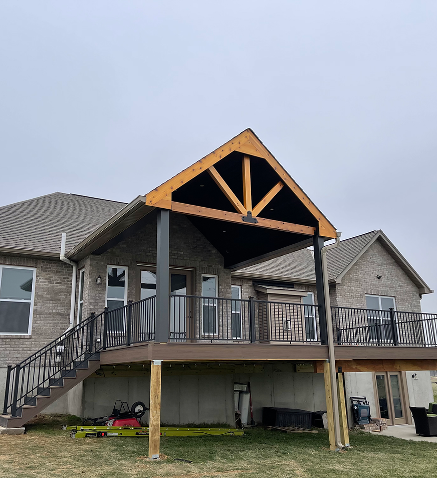 A large house with a large deck and stairs