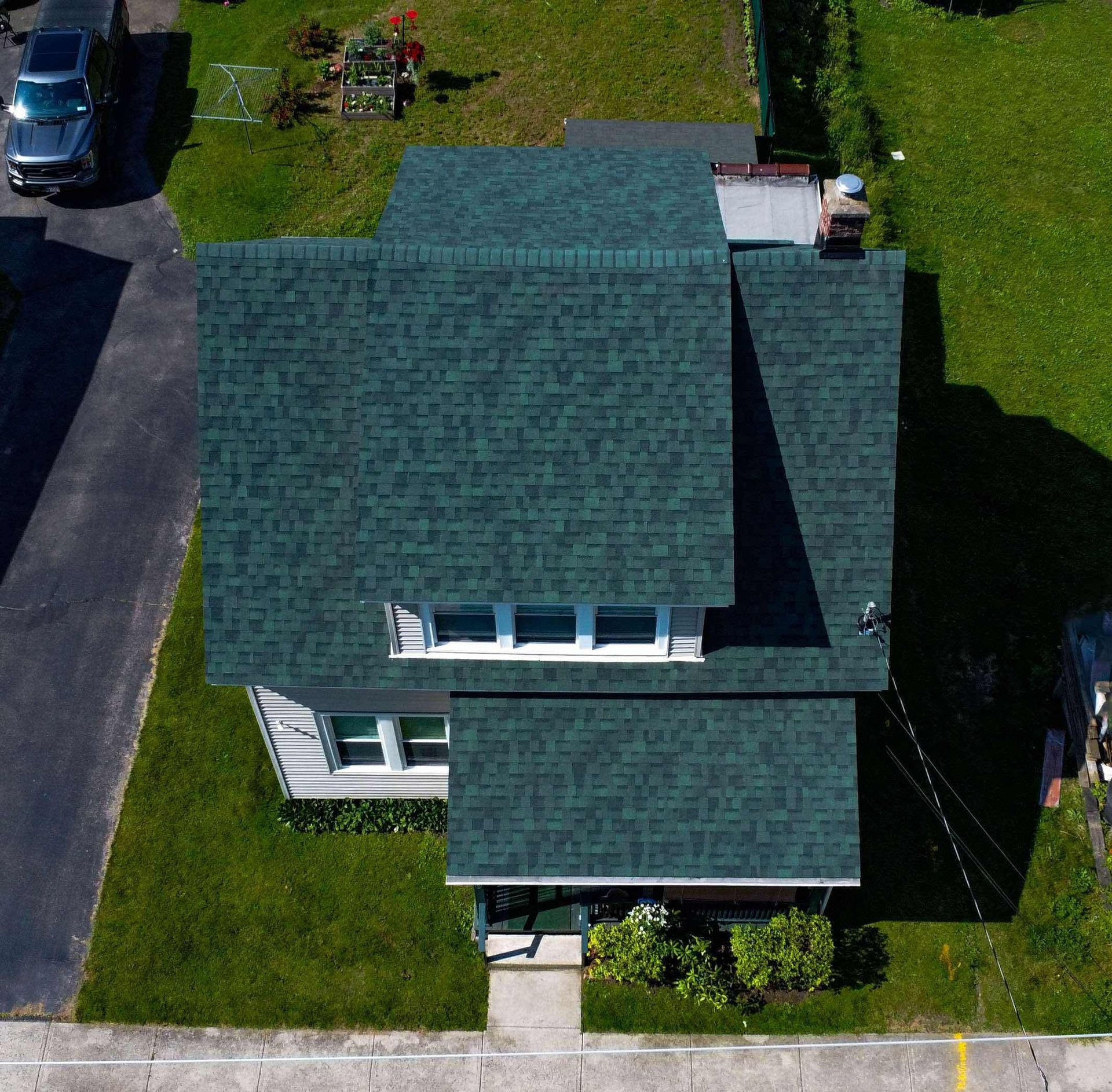 An aerial view of a house with a green roof