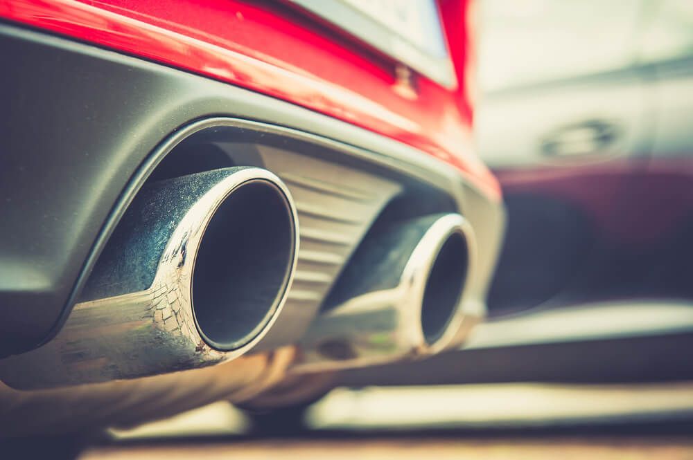 A Close Up of The Exhaust Pipes of A Red Car — Rum City Exhaust Centre in Bundaberg Central, QLD