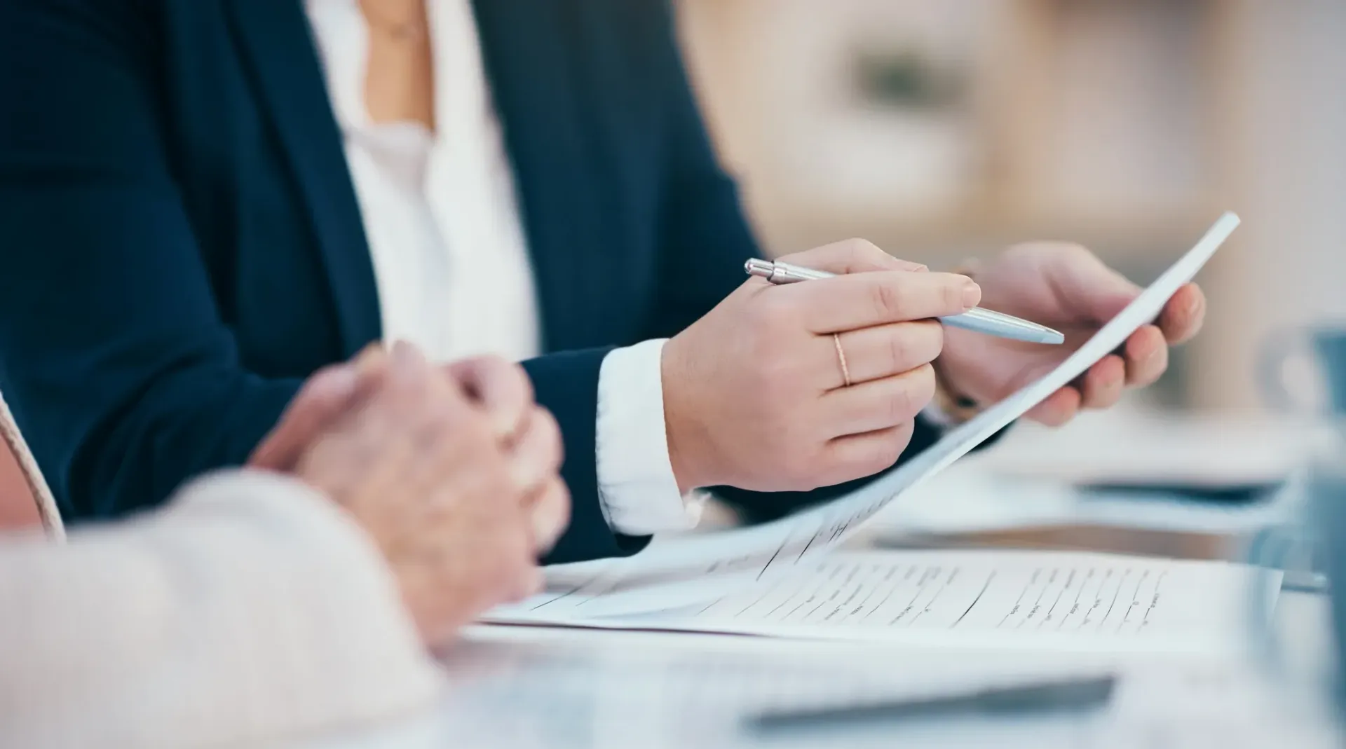 A man and a woman are sitting at a table looking at a piece of paper.