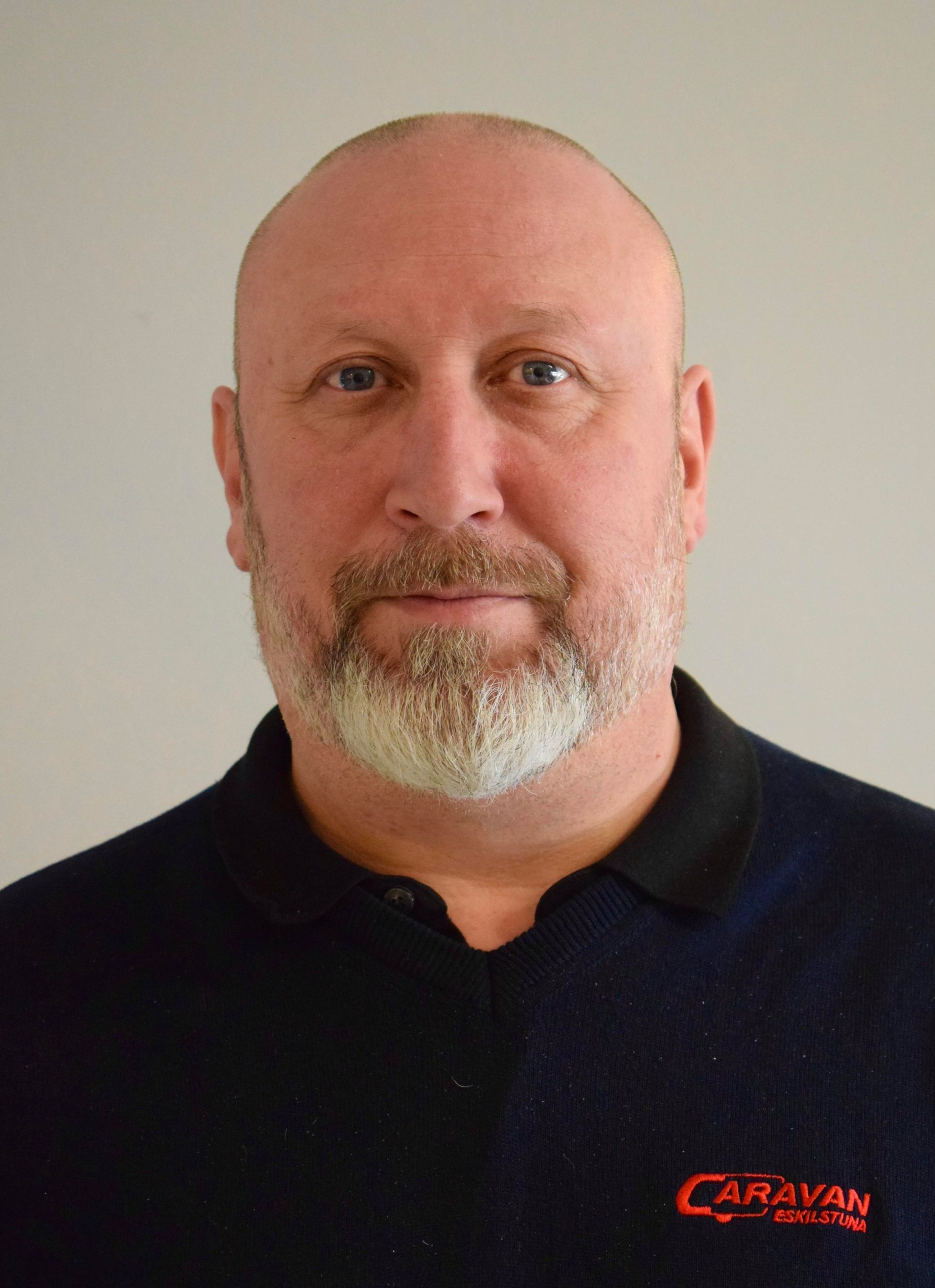 Man with a beard in a black shirt,