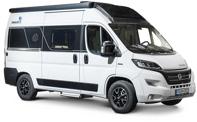 White campervan with black accents parked outdoors, featuring tinted windows and a side step.