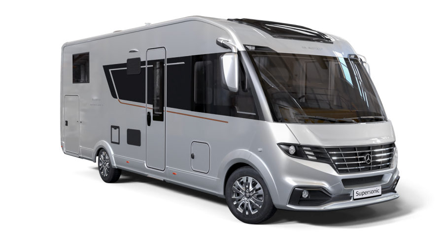 Silver motorhome with black accents, parked against a white background.