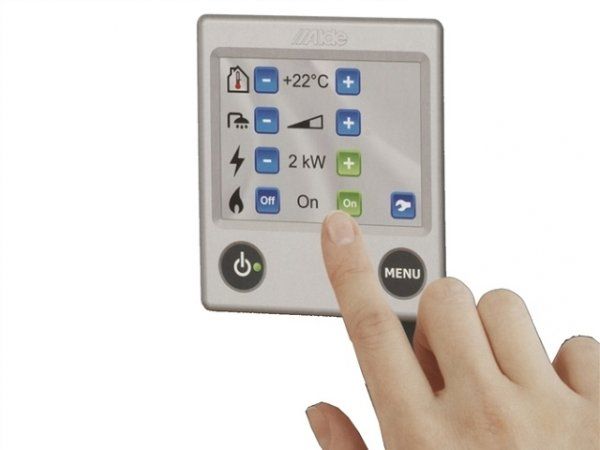 Hand touching a thermostat display with temperature, power, and heating controls visible.