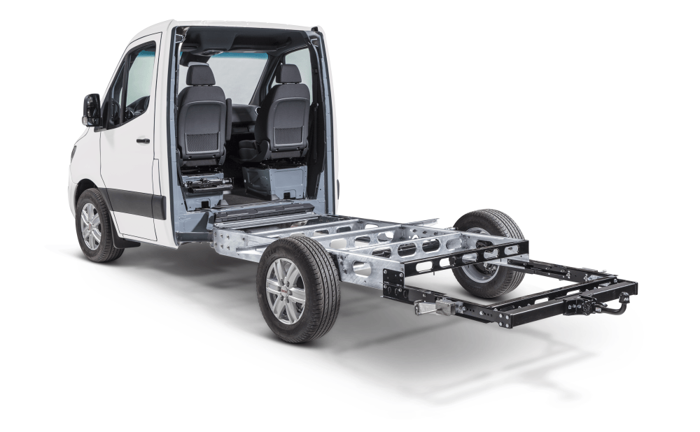White van chassis with seats, displaying the frame beneath the body.