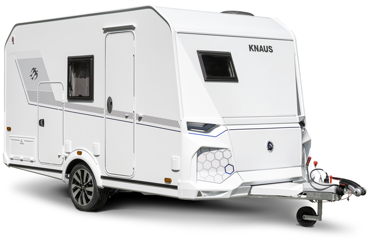 White KNAUS caravan on wheels, angled front view. It has windows, a door, and is hitched to a tow bar.