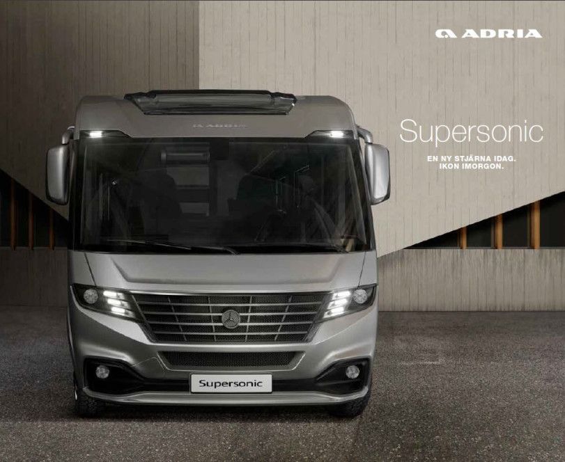 Silver Adria Supersonic motorhome against a neutral background.