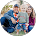 Small circular group photo of several people standing outdoors near trees and water.