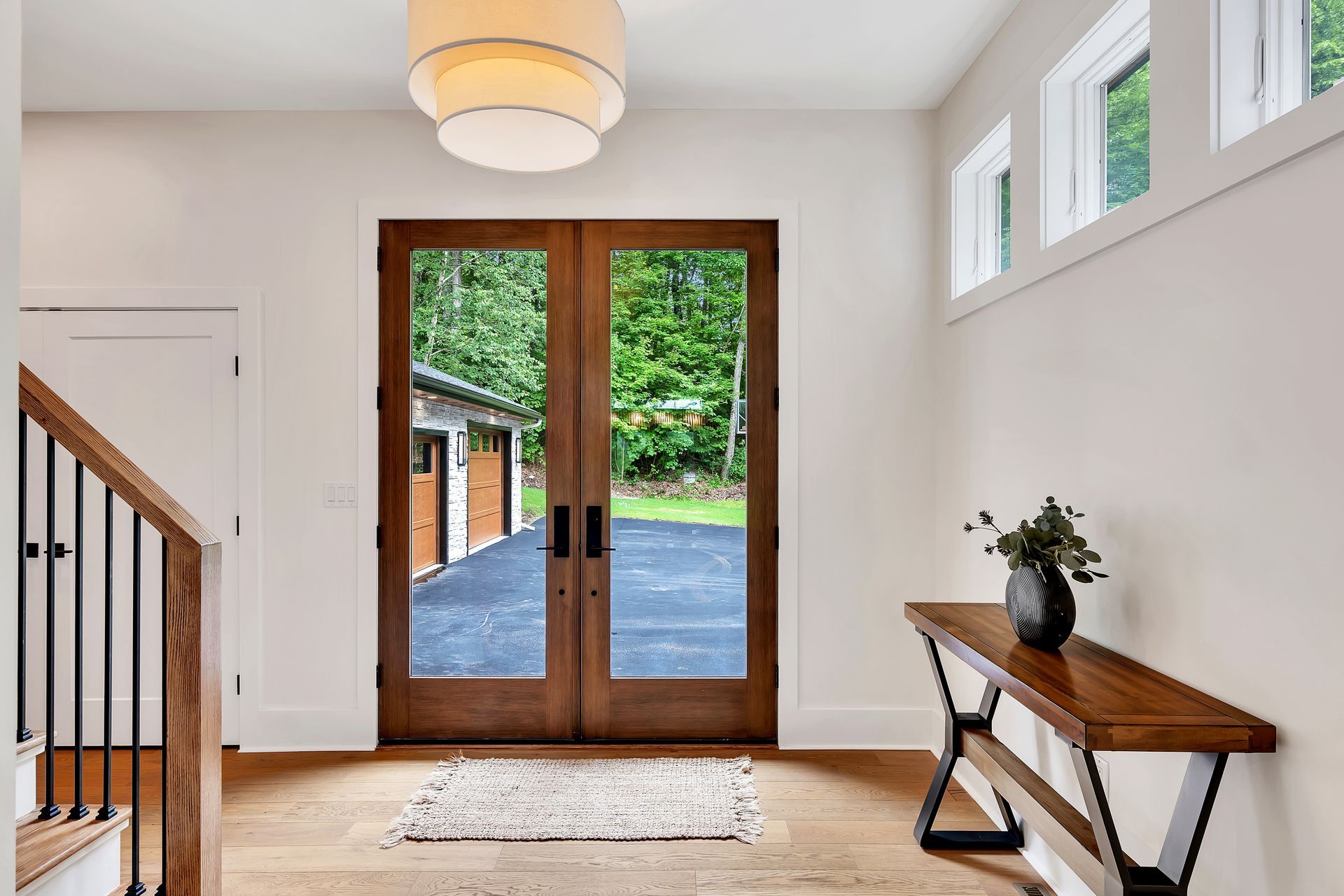 A hallway with a wooden table and a wooden door.