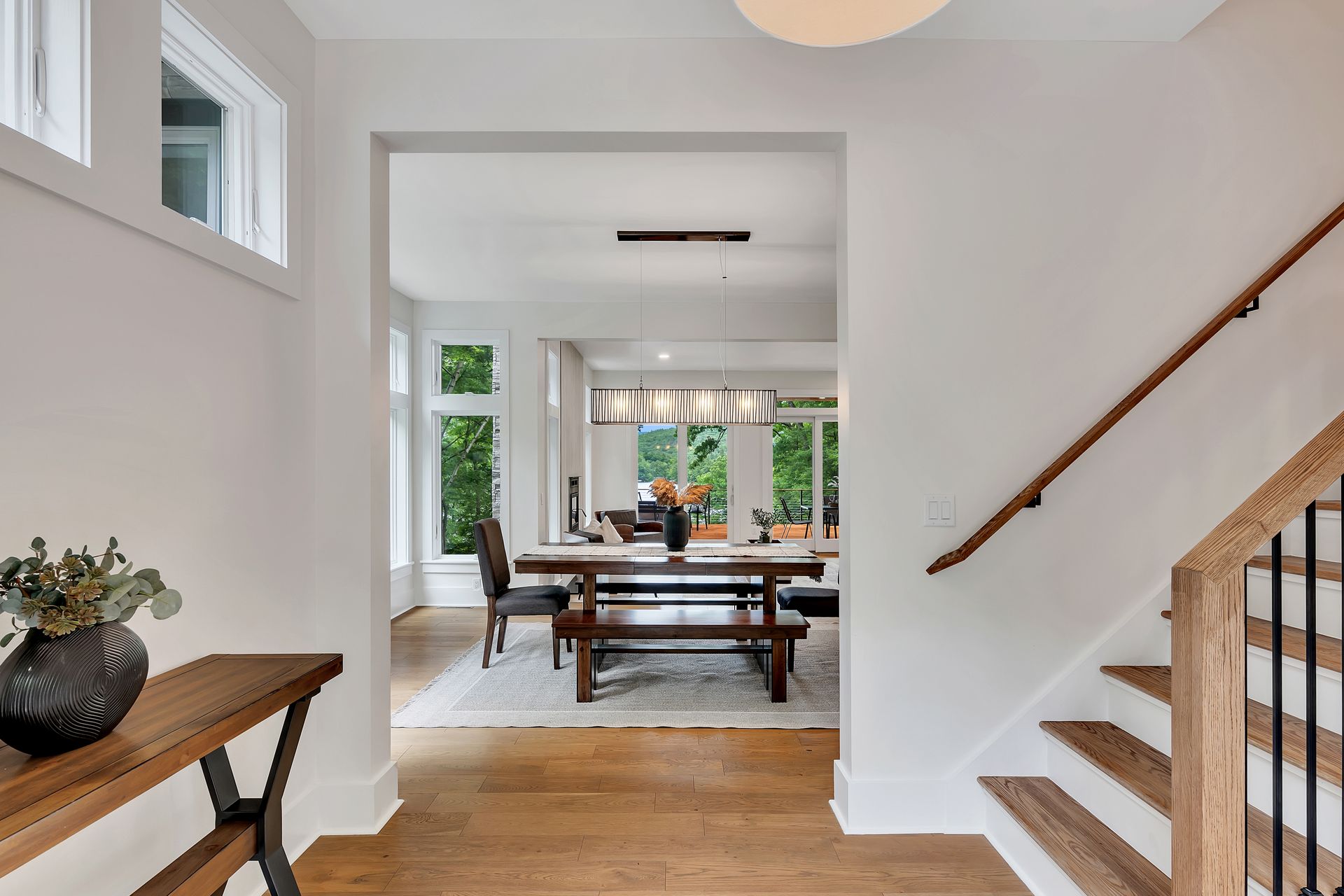A hallway leading to a dining room with a table and chairs.