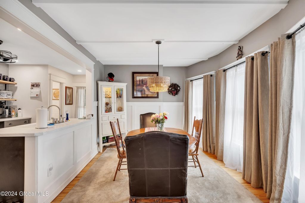 A dining room with a table and chairs in a house.