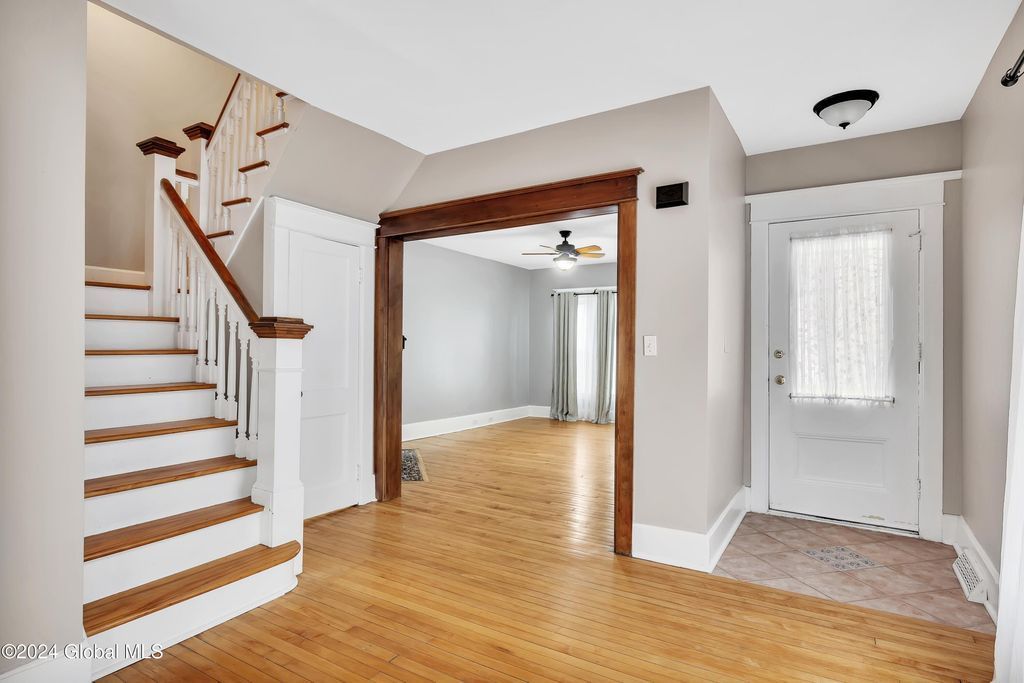 An empty house with stairs leading up to the second floor