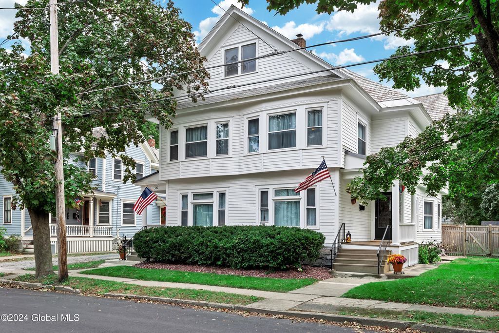 A white house with an american flag on the front of it