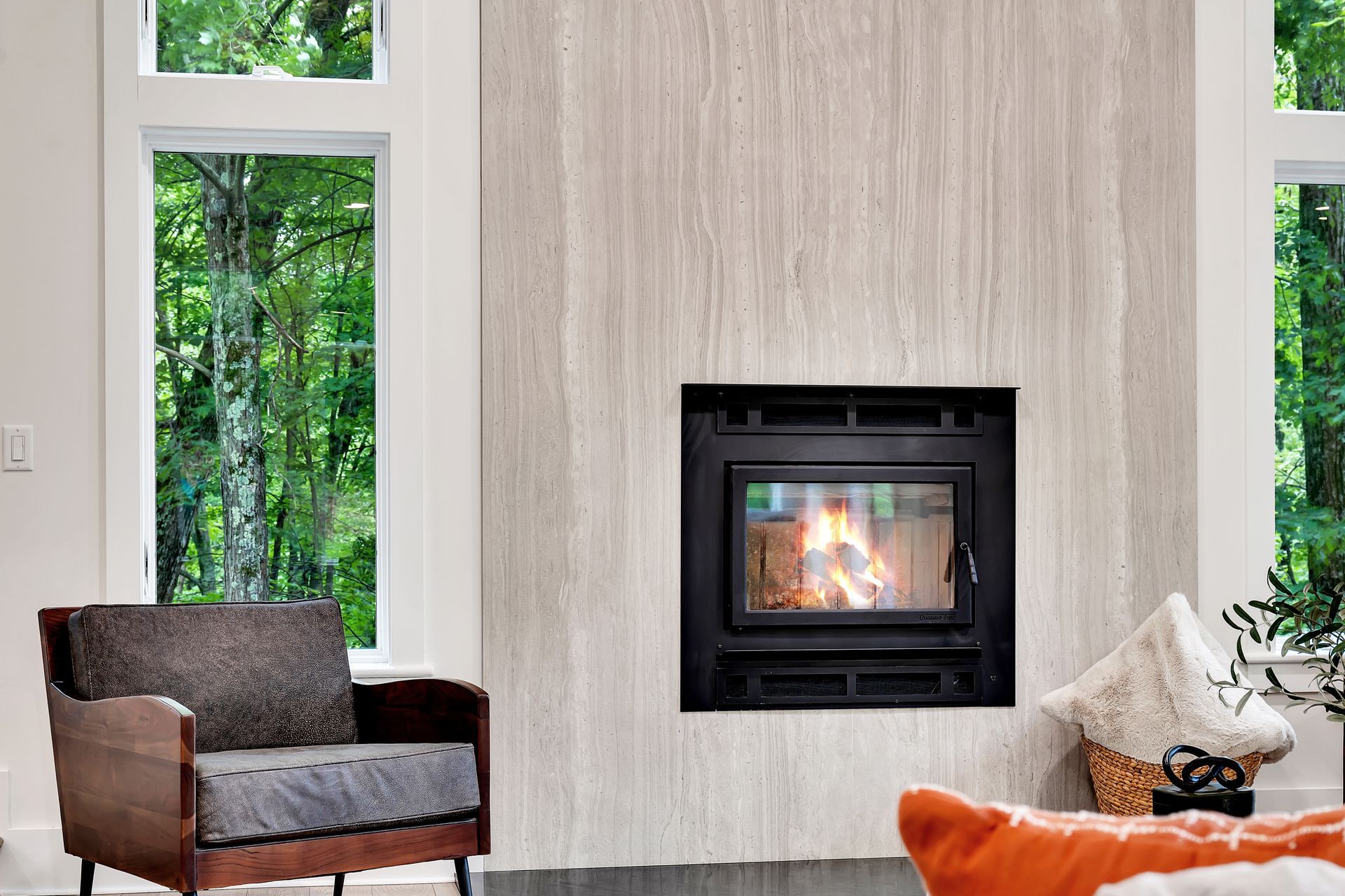 A living room with a fireplace and a chair