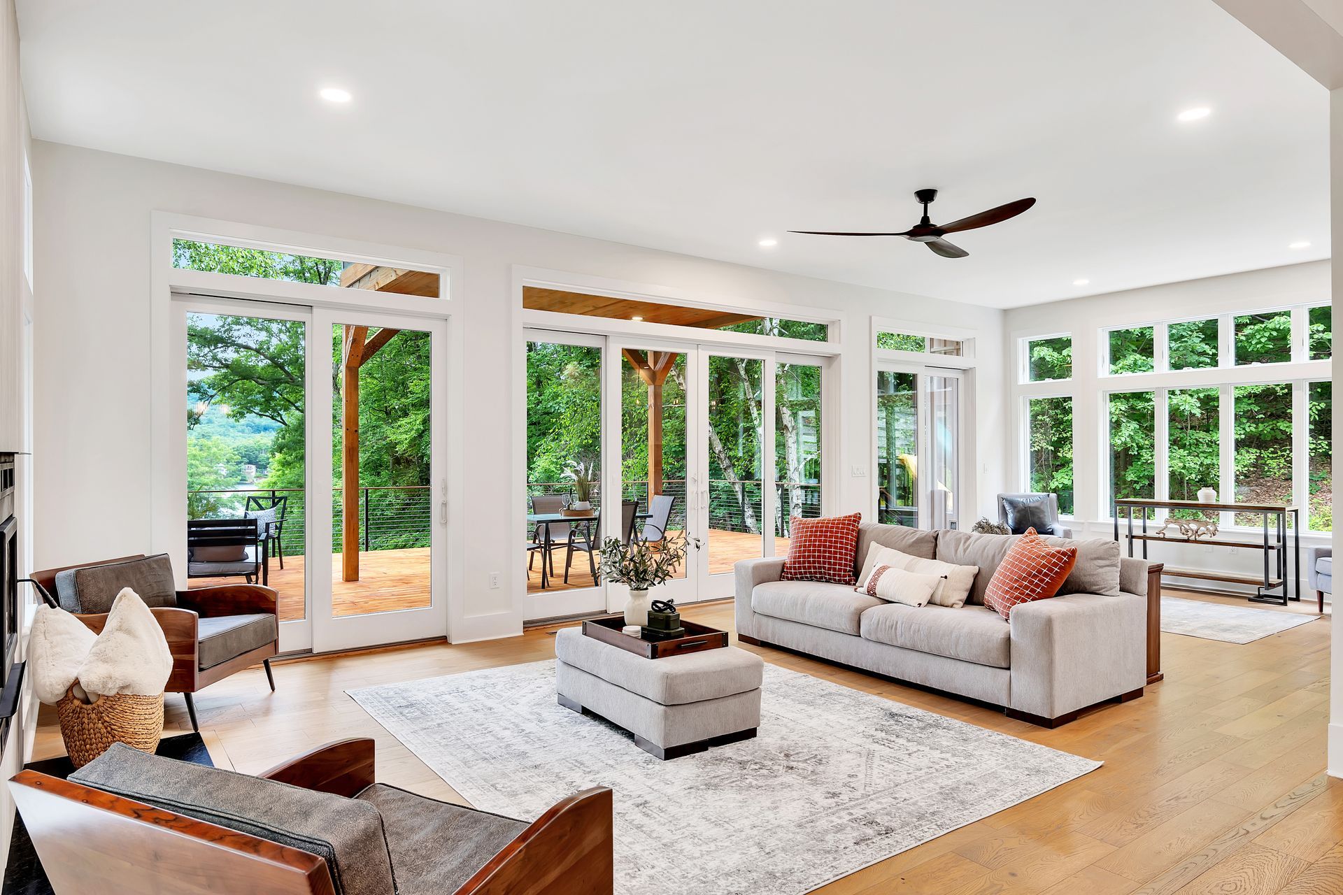 A living room filled with furniture and a ceiling fan.