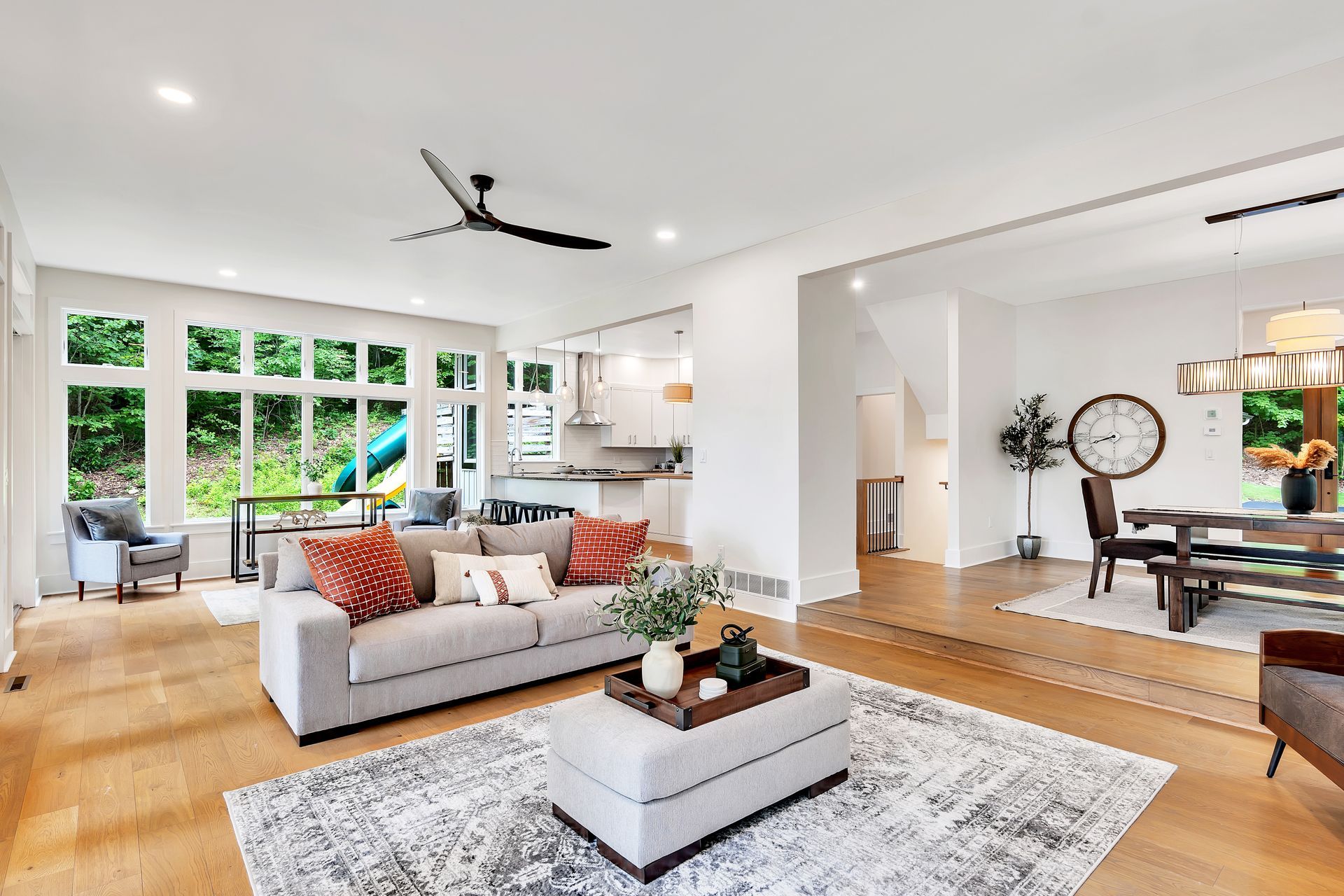 A living room filled with furniture and a ceiling fan.