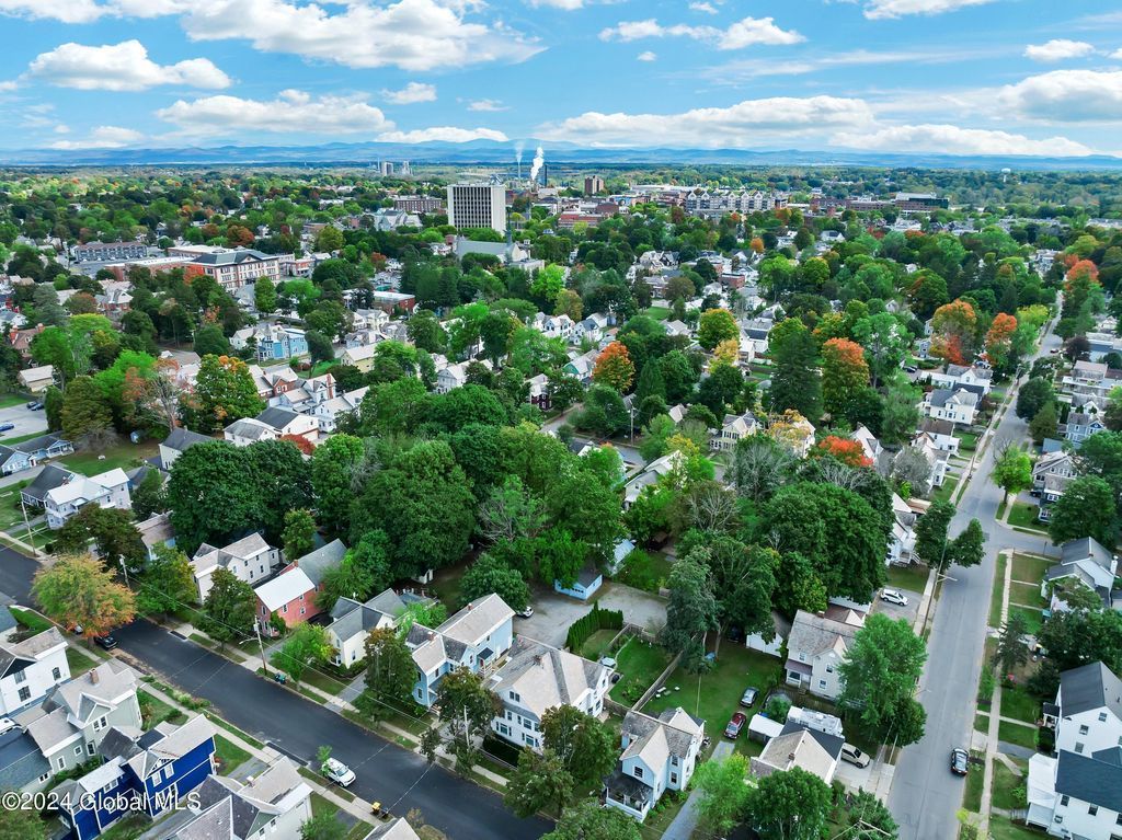 An aerial view of a residential area with lots of trees and houses.