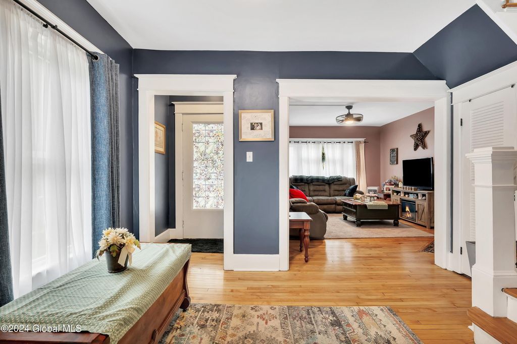 A living room with hardwood floors and blue walls