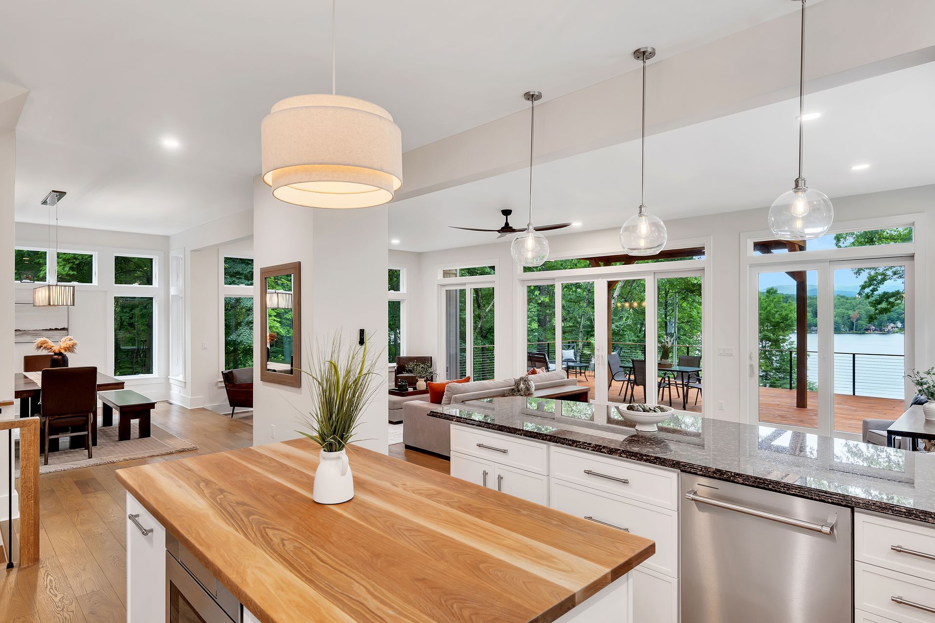 A kitchen with a large wooden island and stainless steel appliances.